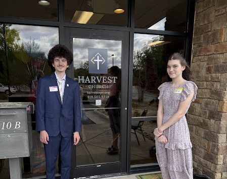 Friendly door greeters welcoming guests at Easter Sunday service